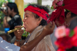 Old woman smoking at a ceremony near Lampang