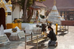 Woman praying at temple ground