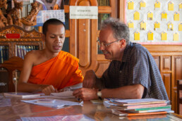 Henk in discussion with a literate monk