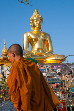 Monk passing buddha statue
