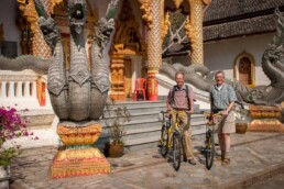 Henk and Eric with bicycles in front of temple